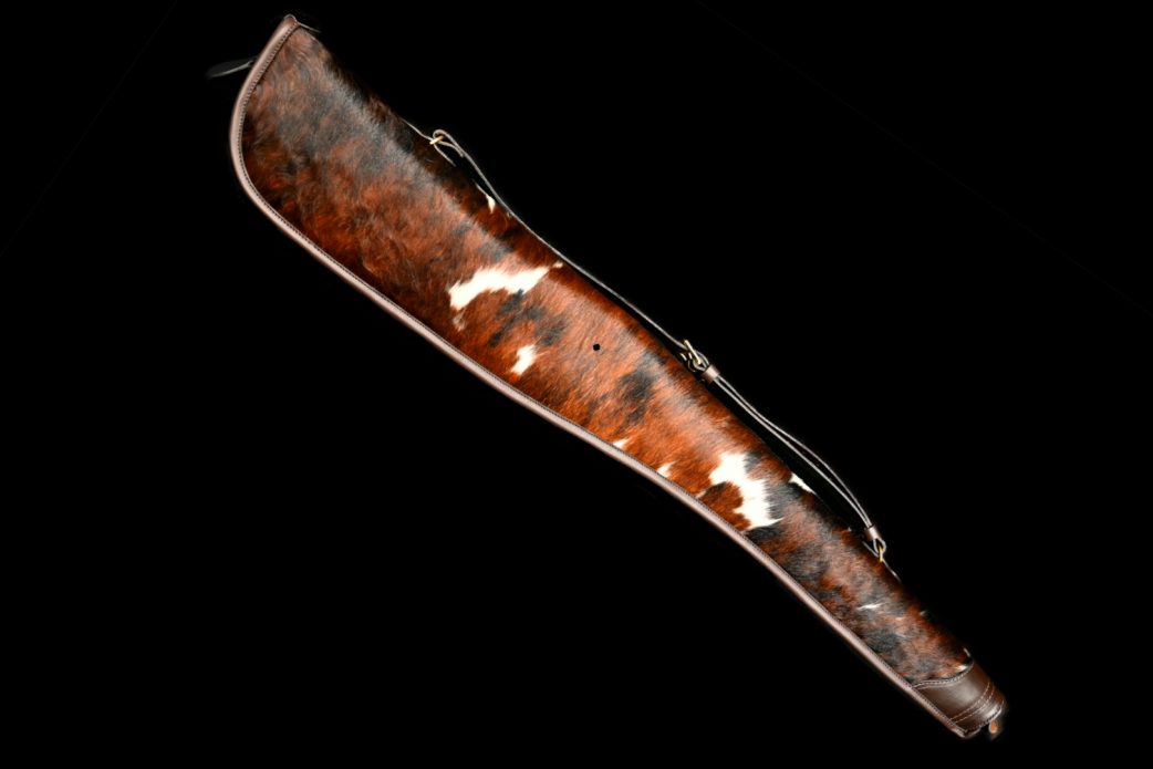 Fleece Lined Shotgun Slip. Gun Slip made with Normandy Cow hide predominantly dark with Dark Havana binding